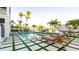 Relaxing outdoor pool area featuring stylish lounge chairs and well-maintained landscaping with tropical palm trees at 531 68Th St, Holmes Beach, FL 34217