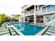 Rear exterior of home with beautiful pool and spa, showcasing modern design and providing a luxurious outdoor space at 531 68Th St, Holmes Beach, FL 34217