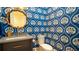 Elegant powder room featuring unique wallpaper, a stylish mirror, and modern fixtures at 531 68Th St, Holmes Beach, FL 34217