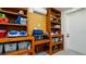 Well-organized storage room with custom wooden shelves and slat wall system for optimal organization at 531 68Th St, Holmes Beach, FL 34217