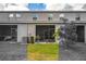 Backyard of home with screened-in patio and green lawn at 10642 Lake Montauk Dr, Riverview, FL 33578