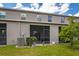 Backyard of home with screened-in patio and green lawn with plants at 10642 Lake Montauk Dr, Riverview, FL 33578