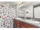 Bathroom with double vanity, granite countertops, and decorative shower curtain at 10642 Lake Montauk Dr, Riverview, FL 33578