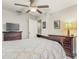 Bedroom showcasing dark wood furniture, a ceiling fan, and natural light from the window at 10642 Lake Montauk Dr, Riverview, FL 33578