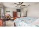 Comfortable bedroom featuring a ceiling fan and a bed with a blue and white patterned comforter at 10642 Lake Montauk Dr, Riverview, FL 33578