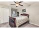Well-lit bedroom with a ceiling fan, window, and closet featuring a patterned bedspread at 10642 Lake Montauk Dr, Riverview, FL 33578