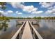Beautiful view from a wooden dock on a serene lake, perfect for relaxation at 10642 Lake Montauk Dr, Riverview, FL 33578