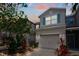 Charming townhome exterior with a two-car garage, neat landscaping, and neutral color palette at 10642 Lake Montauk Dr, Riverview, FL 33578