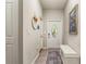 Inviting hallway with decorative tile flooring, neutral walls, and a front door with stained glass at 10642 Lake Montauk Dr, Riverview, FL 33578