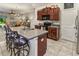 Well-appointed kitchen island with a sink, seating, and modern appliances in an open layout at 10642 Lake Montauk Dr, Riverview, FL 33578