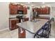 Open kitchen featuring granite countertops, dark wood cabinets, and stainless steel appliances at 10642 Lake Montauk Dr, Riverview, FL 33578