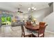 Bright living room with comfortable seating, a ceiling fan, and sliding glass doors to the outside at 10642 Lake Montauk Dr, Riverview, FL 33578
