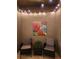 Cozy outdoor space with ambient string lights, seating, and a vibrant floral painting at 10642 Lake Montauk Dr, Riverview, FL 33578
