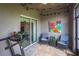 Relaxing screened porch features a treadmill, seating and sliding doors at 10642 Lake Montauk Dr, Riverview, FL 33578