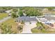 Sprawling single-story home with a three-car garage, lush landscaping, and extended driveway at 11447 Adelia St, Spring Hill, FL 34608