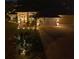 Beautifully landscaped home with inviting driveway and walkway highlighted with stunning outdoor lighting and curb appeal at 11447 Adelia St, Spring Hill, FL 34608