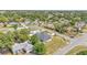 Aerial view of the home in a verdant neighborhood with mature trees at 11447 Adelia St, Spring Hill, FL 34608