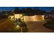 Attractive exterior of a well-maintained home featuring manicured landscaping, a spacious driveway, and warm exterior lighting at 11447 Adelia St, Spring Hill, FL 34608
