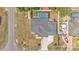 An aerial image displaying the roof, pool, driveway and nearby street at 11447 Adelia St, Spring Hill, FL 34608