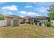 Spacious backyard featuring a screened-in pool and a convenient storage shed at 11447 Adelia St, Spring Hill, FL 34608