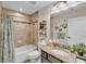 Bathroom featuring tiled shower and bath combination, vanity, and decor at 11447 Adelia St, Spring Hill, FL 34608