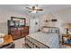Bedroom featuring ceiling fan, dresser, and bed with patterned bedding at 11447 Adelia St, Spring Hill, FL 34608