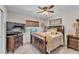 Bedroom featuring a window, a ceiling fan, a dresser, and a television at 11447 Adelia St, Spring Hill, FL 34608