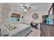 Bedroom featuring ceiling fan, blinds, bed, dresser and wall decor at 11447 Adelia St, Spring Hill, FL 34608