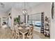 Elegant dining room with views of the pool, a stylish light fixture, and tastefully coordinated decor at 11447 Adelia St, Spring Hill, FL 34608