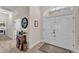 Inviting foyer with double doors, tile floors, and a decorative accent table at 11447 Adelia St, Spring Hill, FL 34608
