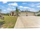 Inviting single-story home with a spacious three-car garage and well-manicured front yard at 11447 Adelia St, Spring Hill, FL 34608