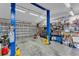 Well-lit garage with car lift, storage shelves, and plenty of space for projects and parking at 11447 Adelia St, Spring Hill, FL 34608