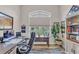 Bright home office with a large window, a comfortable desk chair, and built-in bookshelves for storage at 11447 Adelia St, Spring Hill, FL 34608