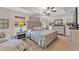 Serene main bedroom featuring a comfortable bed, elegant furnishings, and natural light from the windows at 11447 Adelia St, Spring Hill, FL 34608