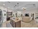 Open-concept kitchen and living area with an island, modern lighting, and stylish decor at 11447 Adelia St, Spring Hill, FL 34608