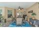 Covered patio with a dining set, ceiling fan, and tranquil view, perfect for outdoor meals and relaxation at 11447 Adelia St, Spring Hill, FL 34608