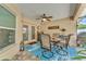 Cozy covered patio featuring a dining set and a bright blue rug, perfect for relaxing outside at 11447 Adelia St, Spring Hill, FL 34608