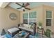 Charming covered patio with wicker furniture, view of pool, and tranquil decor, ideal for outdoor enjoyment at 11447 Adelia St, Spring Hill, FL 34608