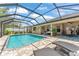 Gorgeous screened-in pool area with patio seating, ideal for entertaining or relaxing outdoors at 11447 Adelia St, Spring Hill, FL 34608