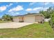 Spacious home with three-car garage featuring stone accents and a well-maintained lawn at 11447 Adelia St, Spring Hill, FL 34608