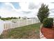 Backyard view with white picket fence overlooking the water and neighborhood homes at 12654 Belcroft Dr, Riverview, FL 33579