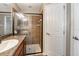 Modern bathroom features a granite countertop, glass shower, and ample lighting at 12654 Belcroft Dr, Riverview, FL 33579