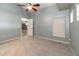 Well-lit bedroom with ensuite bathroom, large window, and ceiling fan at 12654 Belcroft Dr, Riverview, FL 33579