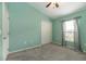Green-walled bedroom with ceiling fan, a large window with curtain and plush carpeting at 12654 Belcroft Dr, Riverview, FL 33579