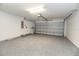Spacious two-car garage with gray floor and electric door that rolls up to the ceiling at 12654 Belcroft Dr, Riverview, FL 33579