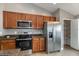 Contemporary kitchen with stainless steel appliances and ample counter space near pantry at 12654 Belcroft Dr, Riverview, FL 33579