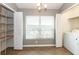 Bright laundry room boasts ample storage, natural light, and modern appliances at 12654 Belcroft Dr, Riverview, FL 33579