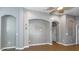 Open-concept living area with recessed lighting, decorative arches, tile floor, and gray walls at 12654 Belcroft Dr, Riverview, FL 33579