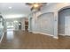 Large living room with open floor plan, tile flooring, decorative columns and archways, and access to backyard at 12654 Belcroft Dr, Riverview, FL 33579