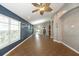 Open-concept living area with tile floors, gray walls, and a ceiling fan, offering a modern and airy feel at 12654 Belcroft Dr, Riverview, FL 33579